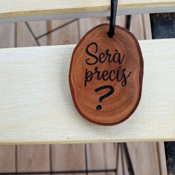 Llavero de madera grabado con frase "Serà precís "